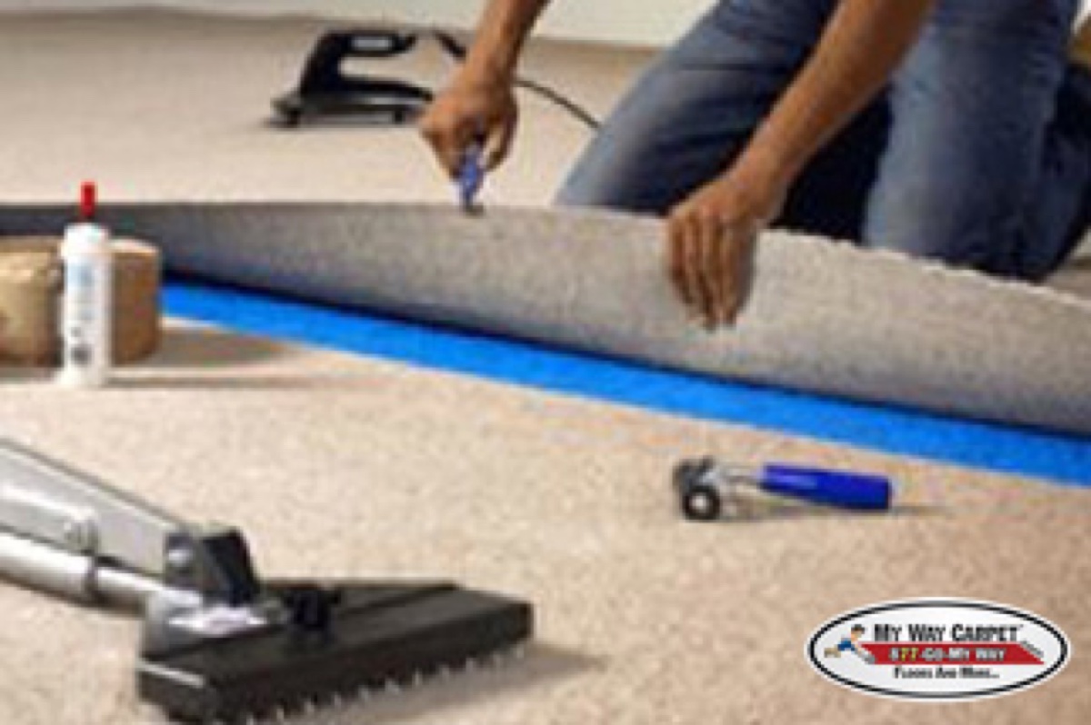 Installer applying seam tape adhesive